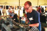 Photo of Jon Gibson Turning Pewter at Sunapee Fair
