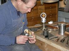 Photo of Jon Gibson restoring antique pewter
