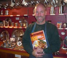 Photo of A Proud Jon Gibson with a copy of New Hampshire Magazine